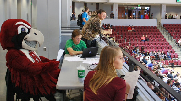 members of the stat crew observing a basketball game with Rooney and working